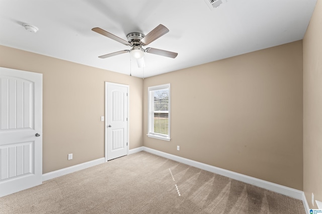 unfurnished room with baseboards, visible vents, a ceiling fan, and light colored carpet