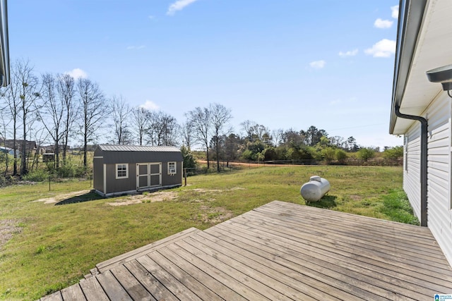 deck featuring an outbuilding, a storage unit, and a yard