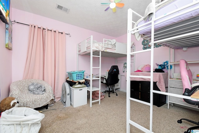 bedroom with a textured ceiling and visible vents