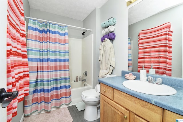 bathroom featuring vanity, toilet, a textured ceiling, shower / bath combination with curtain, and wood finished floors
