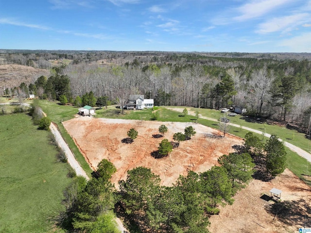 bird's eye view featuring a wooded view and a rural view