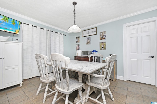 dining room featuring light tile patterned flooring, a textured ceiling, baseboards, and crown molding