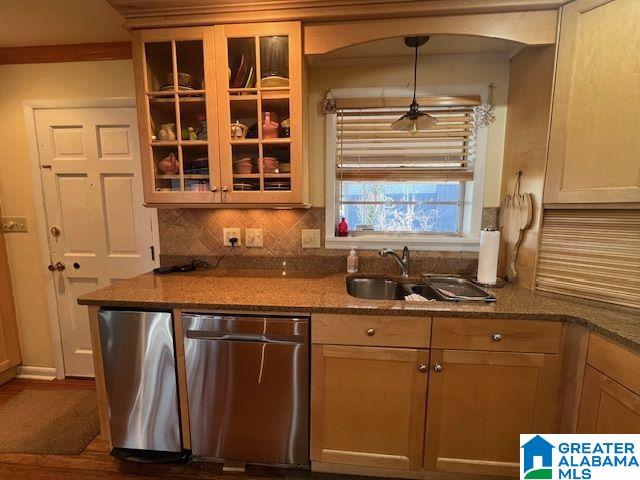881 Ridgeway Cir, Talladega, AL 35160 - kitchen with decorative backsplash, glass insert cabinets, a sink, and stainless steel dishwasher