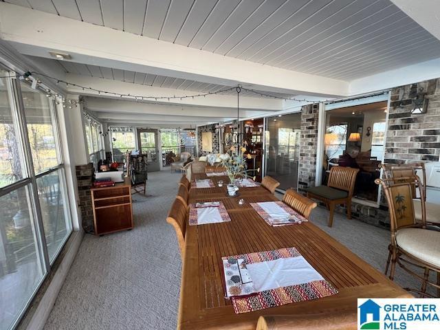 881 Ridgeway Cir, Talladega, AL 35160 - unfurnished dining area featuring carpet floors and beam ceiling