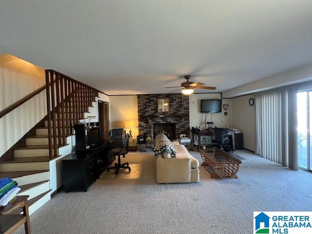 881 Ridgeway Cir, Talladega, AL 35160 - living area featuring a fireplace, stairway, and a ceiling fan