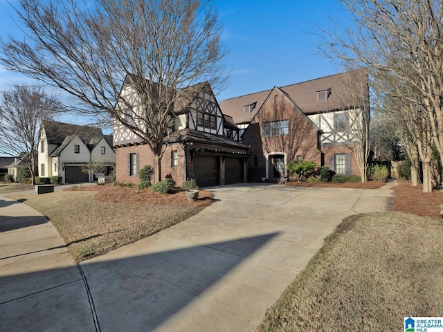 2326 Freestone Ridge Cv, Hoover, AL 35226 - tudor-style house with brick siding, driveway, and an attached garage