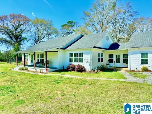 back of property with a lawn