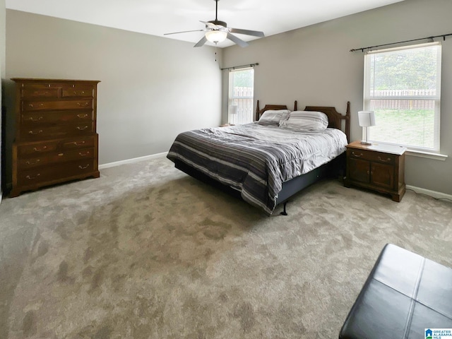 bedroom with light carpet, ceiling fan, and baseboards