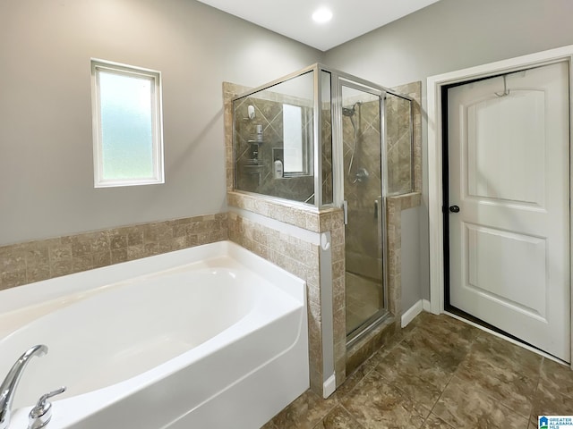 bathroom featuring a garden tub and a stall shower