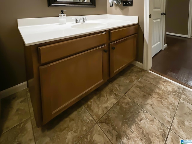 bathroom with vanity and baseboards