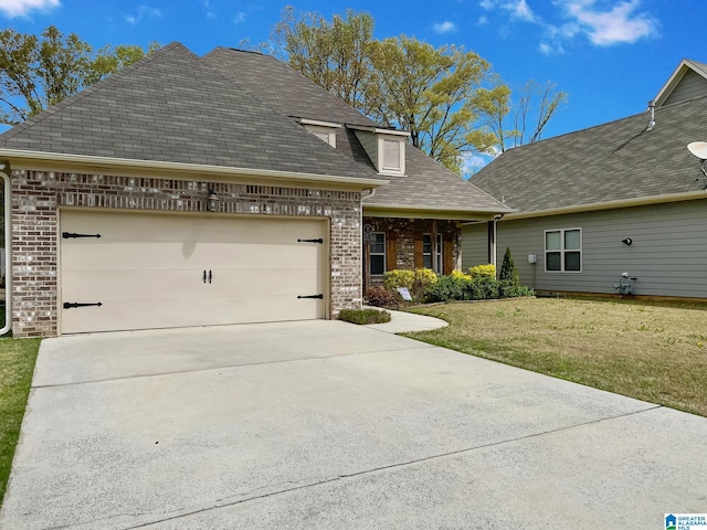 view of front of house with a front yard, brick siding, driveway, and an attached garage