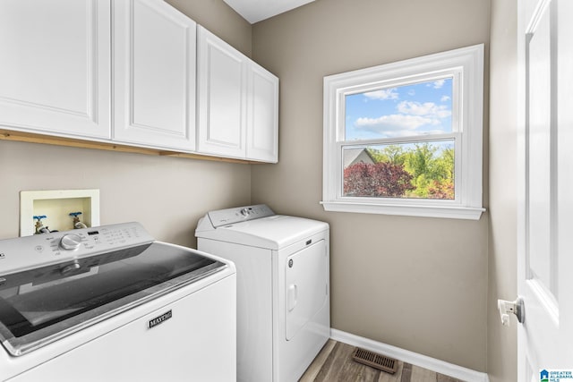 206 Shaw Rd, Pell City, AL 35128 - laundry room with baseboards, visible vents, wood finished floors, cabinet space, and washer and dryer