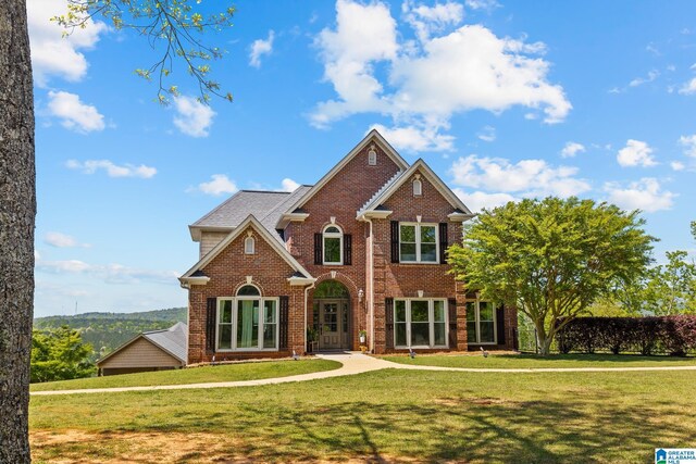 206 Shaw Rd, Pell City, AL 35128 - traditional-style house featuring brick siding and a front yard