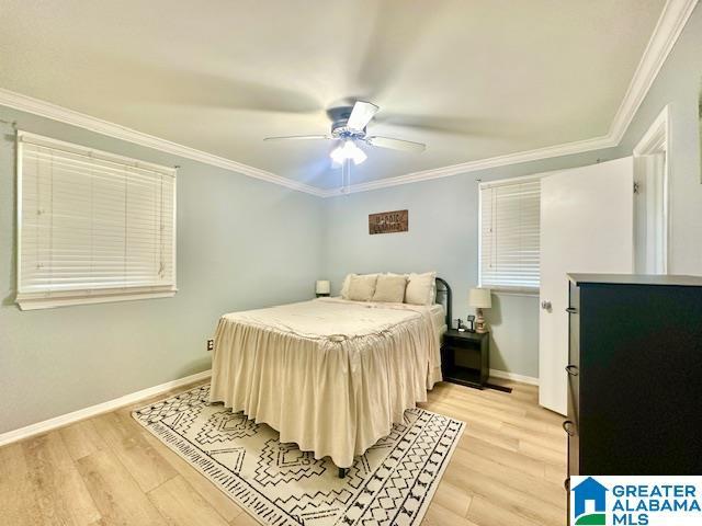 bedroom featuring baseboards, a ceiling fan, light wood-style flooring, and crown molding