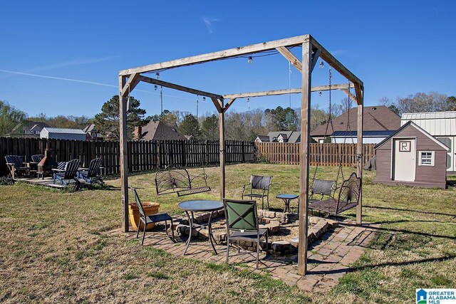 8014 Waterford Dr, Pinson, AL 35126 - view of yard featuring a fenced backyard, a storage unit, an outdoor structure, and a patio area