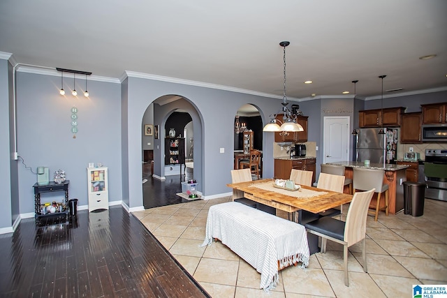 8014 Waterford Dr, Pinson, AL 35126 - dining room featuring crown molding, arched walkways, baseboards, and recessed lighting
