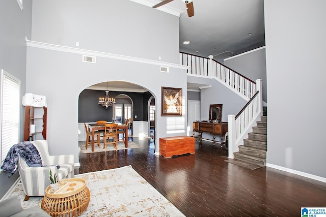 8014 Waterford Dr, Pinson, AL 35126 - living room featuring visible vents, stairs, wood finished floors, a high ceiling, and arched walkways