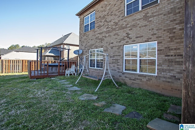 8014 Waterford Dr, Pinson, AL 35126 - exterior space with a fenced backyard, a wooden deck, a lawn, and brick siding