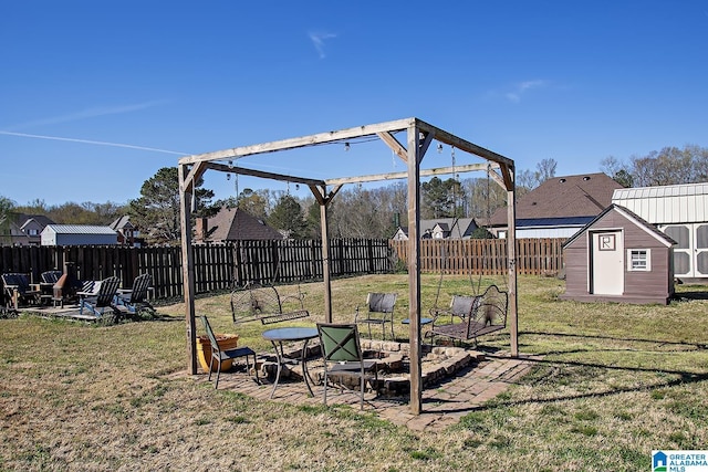 8014 Waterford Dr, Pinson, AL 35126 - view of yard with an outdoor structure, a fire pit, a patio, a fenced backyard, and a shed