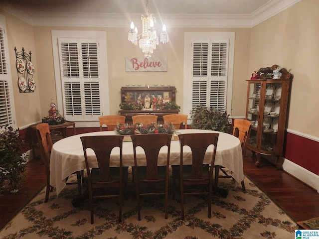 dining area with crown molding, baseboards, a chandelier, and wood finished floors