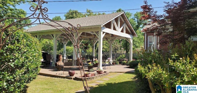 surrounding community with a lawn, a gazebo, and a patio