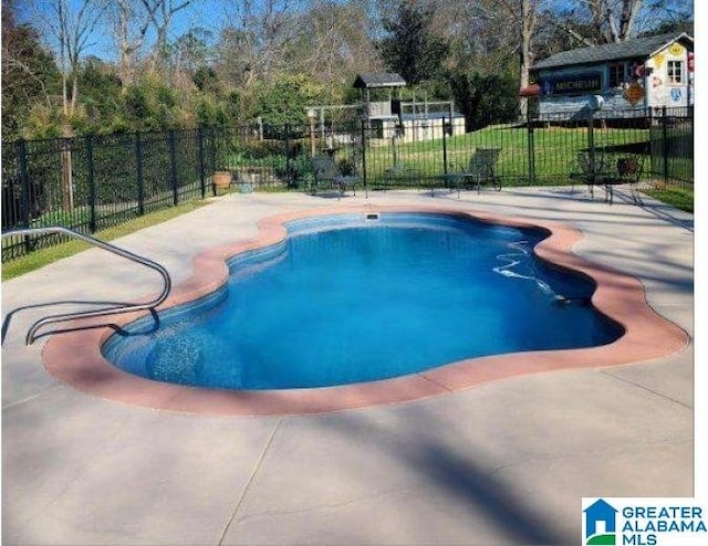 view of swimming pool with fence, a fenced in pool, and a patio area