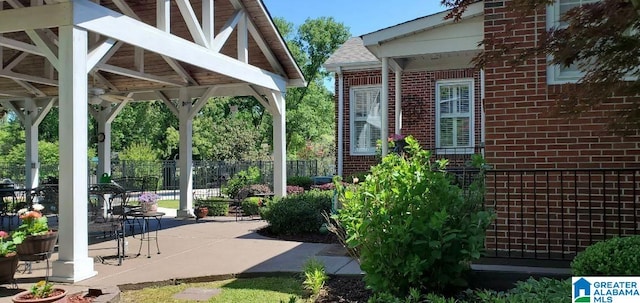 view of patio featuring fence