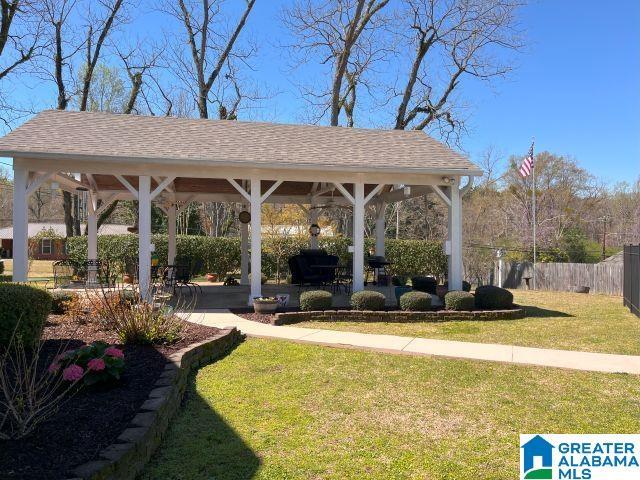 surrounding community with fence, a gazebo, and a yard