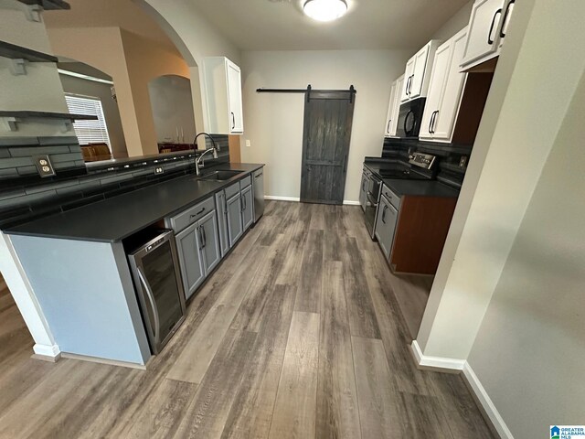 6777 Southern Trace Cir, Leeds, AL 35094 - kitchen featuring dark countertops, dark wood-style flooring, appliances with stainless steel finishes, and a sink