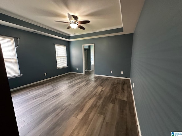 6777 Southern Trace Cir, Leeds, AL 35094 - unfurnished room featuring a ceiling fan, a tray ceiling, baseboards, ornamental molding, and dark wood-style floors