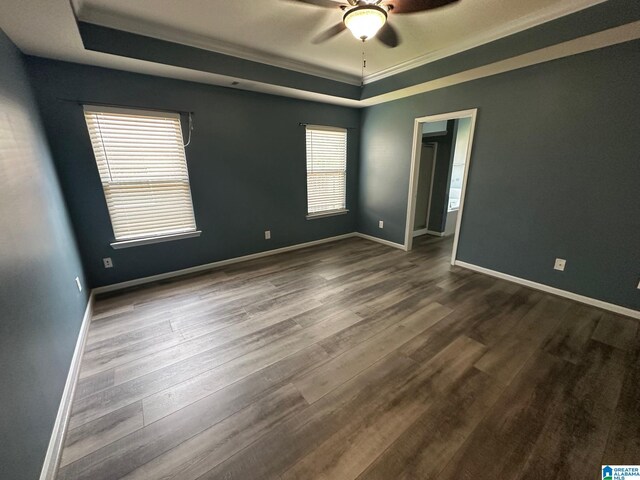 6777 Southern Trace Cir, Leeds, AL 35094 - unfurnished room featuring a tray ceiling, a ceiling fan, baseboards, and dark wood-style flooring