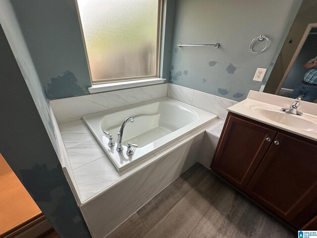 6777 Southern Trace Cir, Leeds, AL 35094 - bathroom with a garden tub, wood finished floors, and vanity