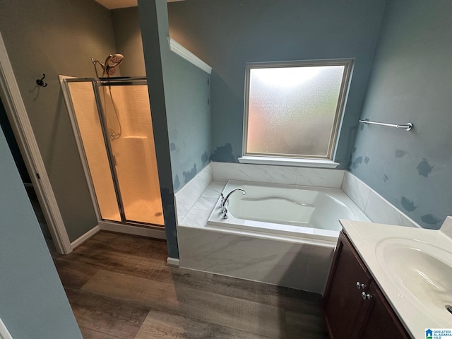 6777 Southern Trace Cir, Leeds, AL 35094 - bathroom featuring a shower stall, a bath, vanity, and wood finished floors