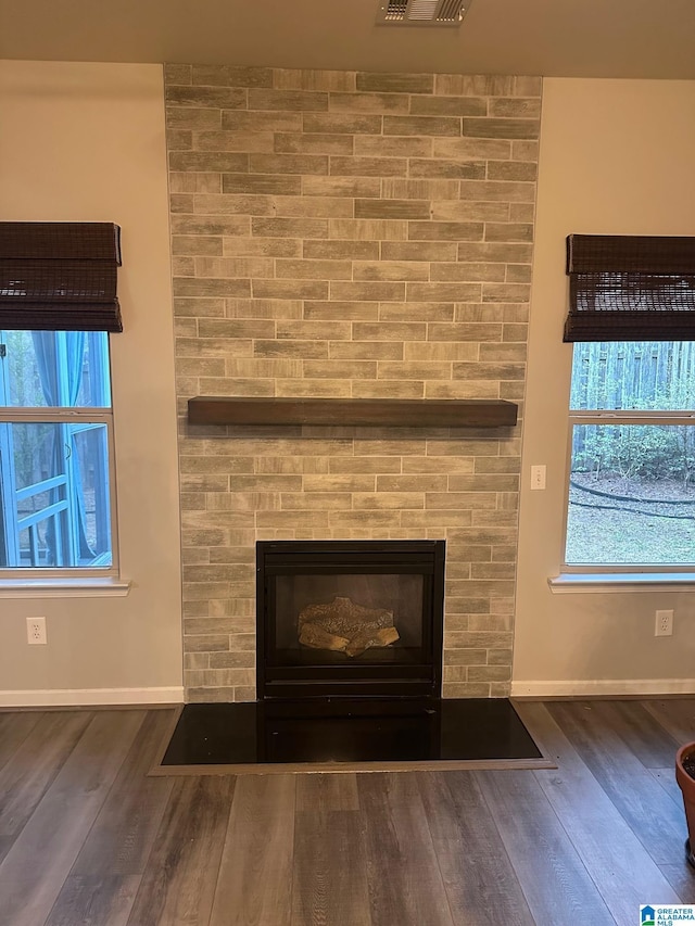 6777 Southern Trace Cir, Leeds, AL 35094 - room details featuring baseboards, wood finished floors, a large fireplace, and visible vents