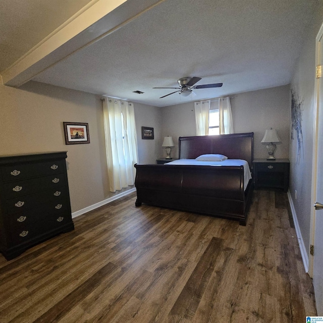bedroom featuring baseboards, ceiling fan, a textured ceiling, and dark wood-style flooring