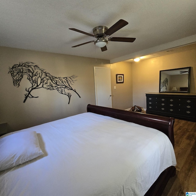 bedroom with wood finished floors and a ceiling fan