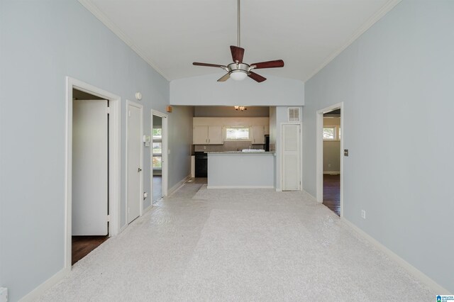 unfurnished living room with crown molding, ceiling fan, and light carpet