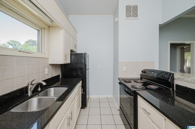 kitchen featuring visible vents, white cabinets, a sink, black appliances, and decorative backsplash