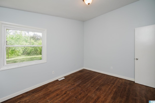 empty room with baseboards and wood finished floors