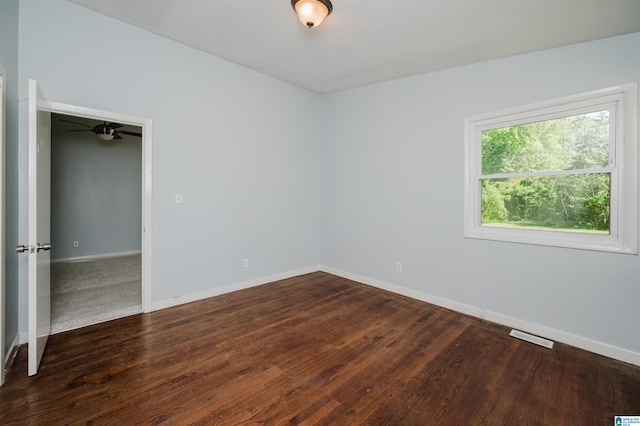 unfurnished bedroom featuring visible vents, baseboards, and wood finished floors