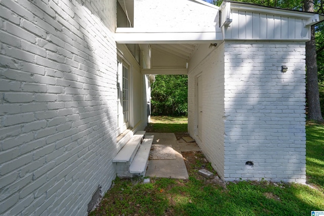 view of side of property with brick siding