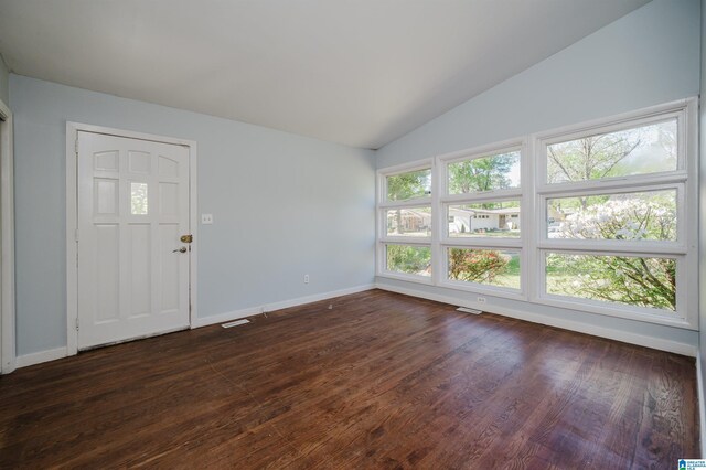 foyer with baseboards, dark wood finished floors, and vaulted ceiling