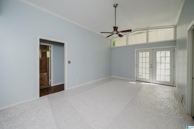 carpeted empty room featuring french doors, baseboards, a ceiling fan, and crown molding
