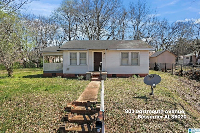 bungalow-style home with fence, roof with shingles, crawl space, and a front yard