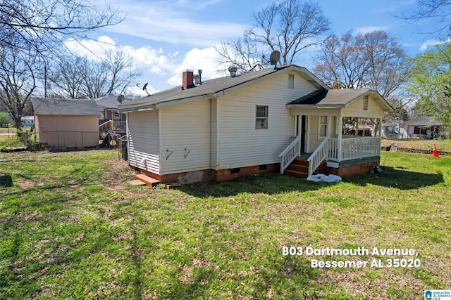 rear view of house with crawl space, a chimney, roof with shingles, and a lawn