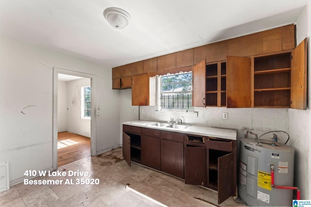 kitchen with a healthy amount of sunlight, electric water heater, a sink, and open shelves