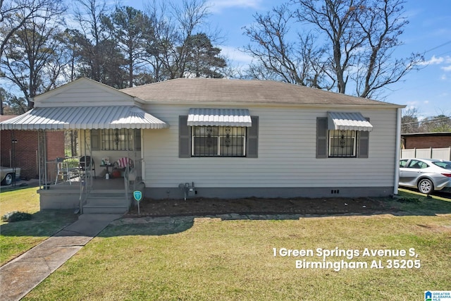 bungalow featuring a shingled roof, a front lawn, and crawl space