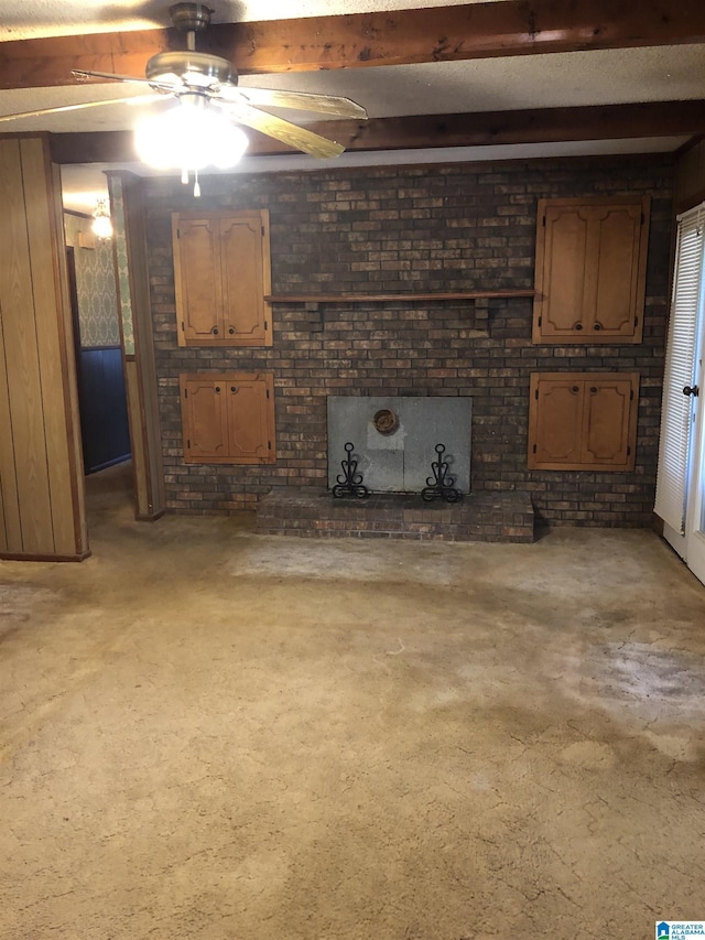 unfurnished living room with beamed ceiling and ceiling fan