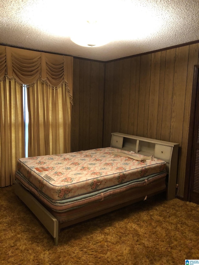carpeted bedroom with wooden walls