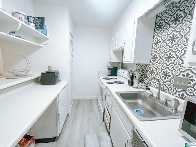 kitchen with light countertops, a sink, white cabinetry, white range with electric cooktop, and light wood-style flooring